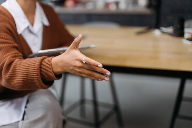 istock young woman holding out her hand for a handshake 1390673358