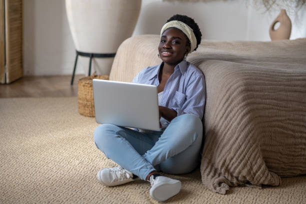 istock African american woman chatting on internet and looking interested 1390674315