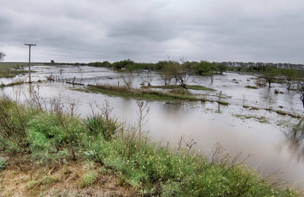 istock overflowing stream flooding a field due to heavy rain. 1390675075