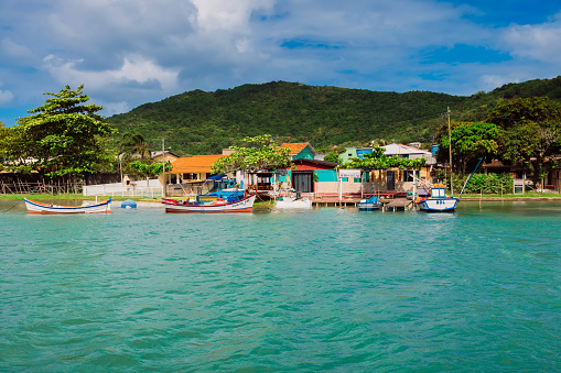 January 6, 2022. Florianopolis, Brazil. Canal of Barra da Lagoa with blue water, boats and houses