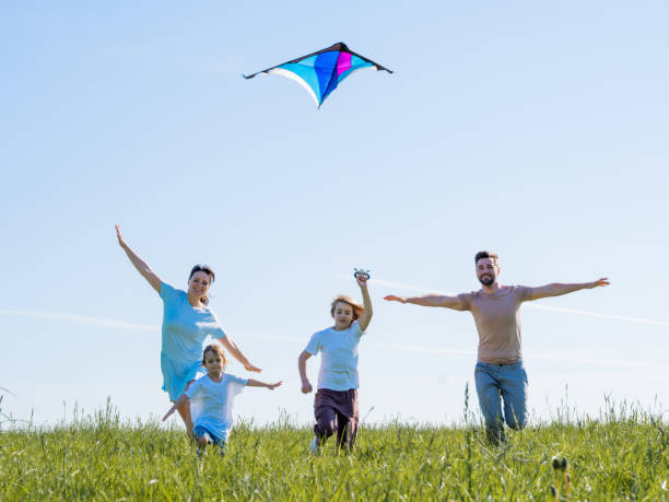 istock Family running through field with fly 1390677646