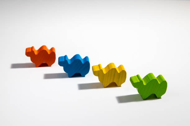 istock Wooden colorful camels walking on a white background with select focus blur 1390678027