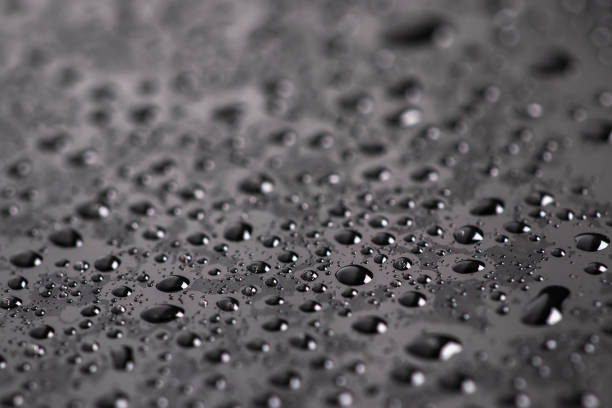 istock Water drops on the surface covered with foil. Surface tension. 1390679410