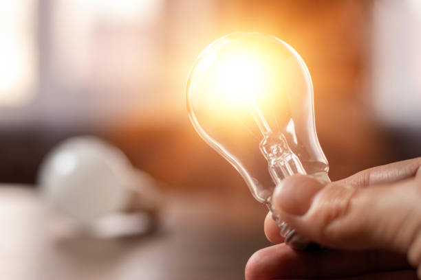 istock Hand holding light bulb. idea concept with innovation and inspiration 1390680161