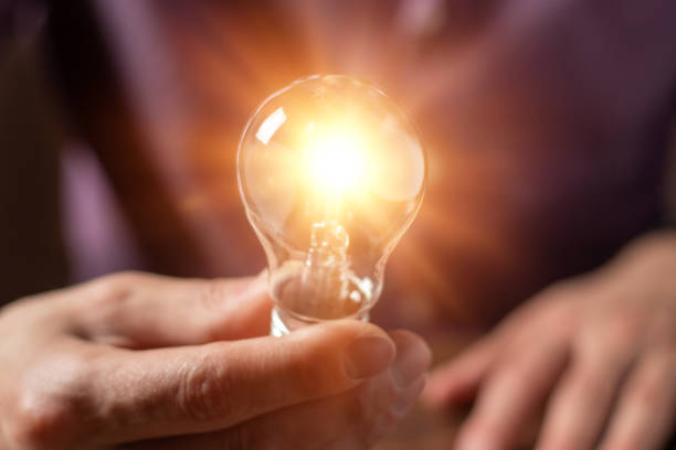 istock Hand holding light bulb. idea concept with innovation and inspiration 1390680188