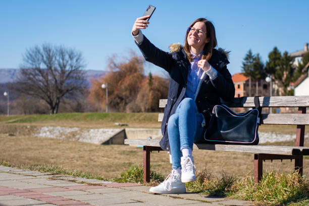 istock Female student on a break taking a selfie 1390680275