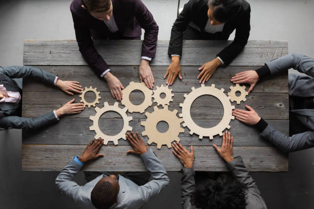 istock Business people joining together gears 1390680533