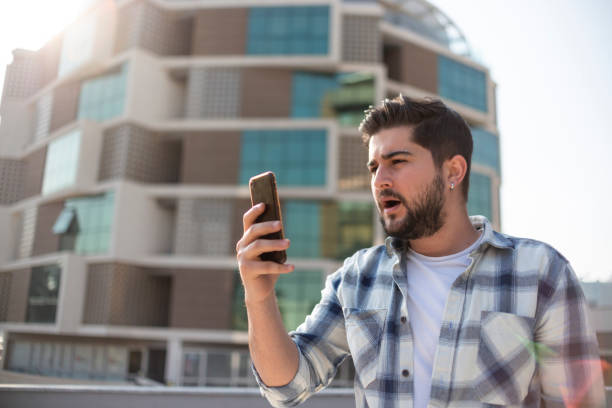 istock Upset man looking at his mobile phone 1390683586