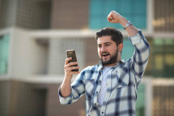 istock Ecstatic young man learning good news on smartphone 1390683780