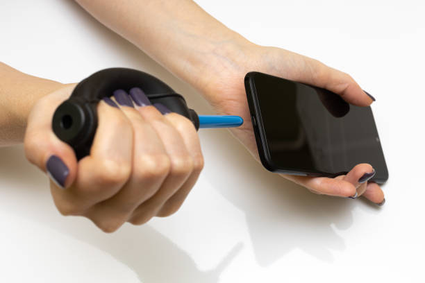 istock hand presses on the pear and blows dust off the phone 1390686478