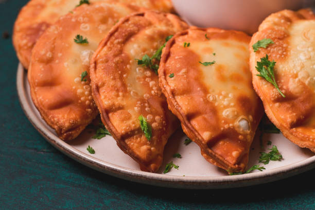 istock Fried mini pasties, with red sauce, top view, close-up, no people, selective focus, 1390686661