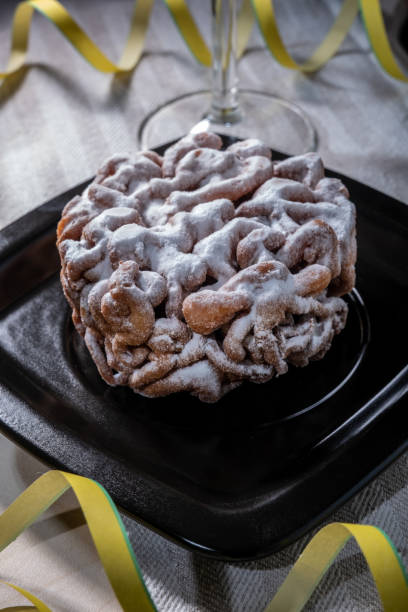Traditional Finnish cuisine: Funnel cakes with powdered sugar topping are eaten around May 1st with homemade Sima (mead) stock photo