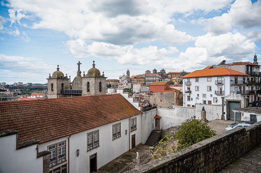 Rooftops and beautiful colorful buildings in the city of Porto in Portugal with a view of the Porto Cathedral. Built in the highest point in the city, the Sé Cathedral is the most important religious building in Porto.