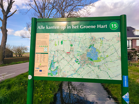 Waddinxveen, Netherlands - April 2022: Map with cycling and walking routes at the side of the road. Area is called Green Heart of Holland (Dutch: Groene Hart) and can be found between cities of Amsterdam, Rotterdam, The Hague and Utrecht.