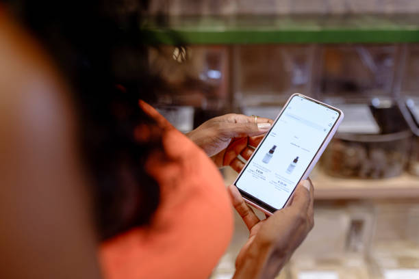 istock Detail of female hands with cellphone checking values in e-commerce 1390693262