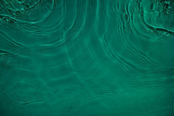 istock transparent dark green colored clear calm water surface texture 1390694202