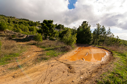 Country road with mud at Penteli mountain at Attica, Greece. Mount Penteli is a mountain in Attica, Greece, situated northeast of Athens and southwest of Marathon.