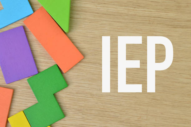 istock Wooden background written with IEP stands for Individualized Educational Program. 1390695935