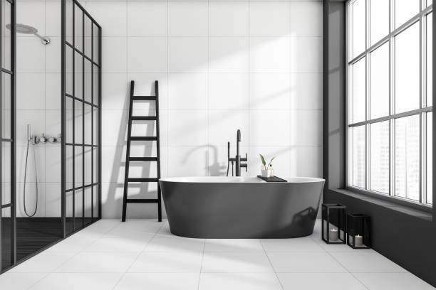 istock Light bathroom interior with bathtub and douche, panoramic window 1390696908