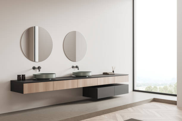 istock Light bathroom interior with sink and mirror, accessories and panoramic window 1390696962