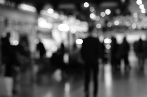 Blurred background. People in the mall. Black and white photo.