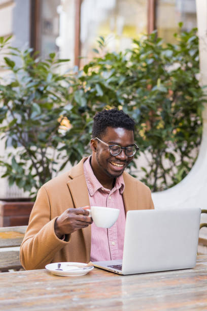 istock Attractive African-American man drinking coffee outside 1390697237