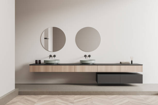 istock Light bathroom interior with sink and mirror, decoration on drawer 1390698366