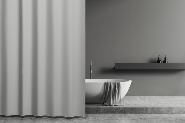istock Grey bathroom interior with tub and accessories, rack and blank curtain 1390698598