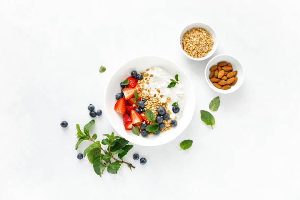 istock Breakfast bowl with granola, plain yogurt, strawberry and blueberry, top view 1390699543