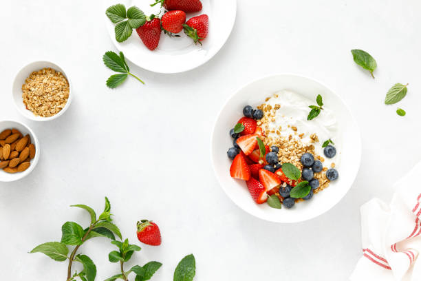 istock Breakfast bowl with granola, plain yogurt, strawberry and blueberry, top view 1390699551