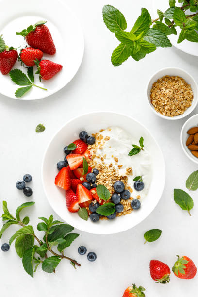 istock Breakfast bowl with granola, plain yogurt, strawberry and blueberry, top view 1390699560