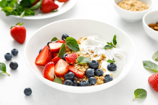 istock Breakfast bowl with granola, plain yogurt, strawberry and blueberry 1390699566