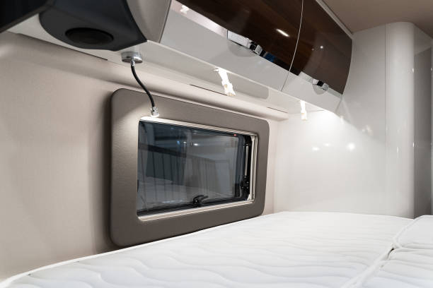 istock bed near window in luxury RV camper trailer 1390699817
