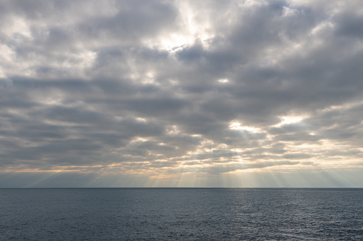 View of the rays of the sun shining on the sea