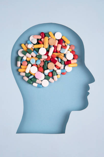 Human head in paper cut style with pills