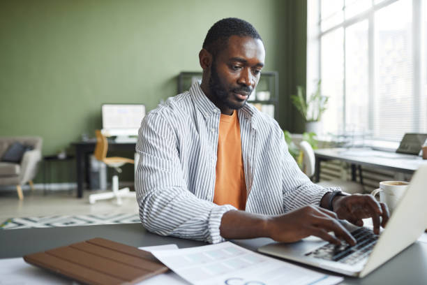 istock African American Businessman using Laptop in Office 1390703978