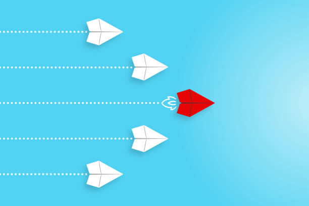 istock Leadership concepts with red paper airplane leading among white 1390705673