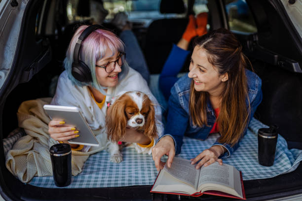 istock Happy family and their dog going on a car trip in spring. 1390706549