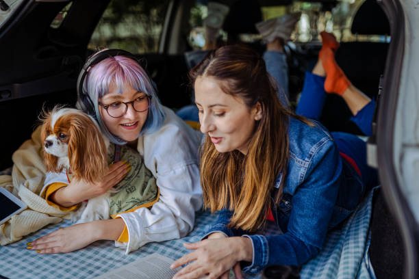istock Happy family and their dog going on a car trip in spring. 1390706611
