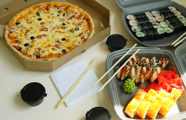 istock Delivery and takeout food. Ready to eat. Pizza and sushi in box. 1390706830