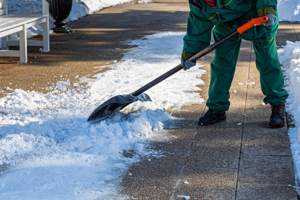 istock janitor cleans the sidewalk from snow with a shovel 1390708602