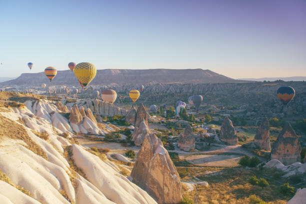 istock Hot air balloons flying over Cappadocia landscape 1390709558