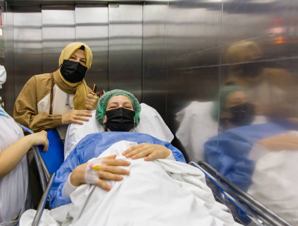istock Surgery Patient Woman in Hospital Elevator 1390710890