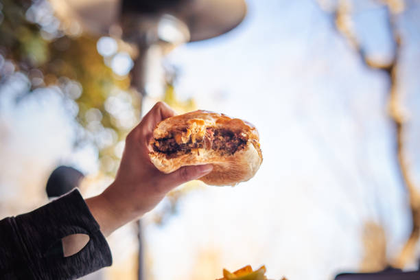 istock Close Up to a Nice Juicy Eaten Burger in Hands 1390711761