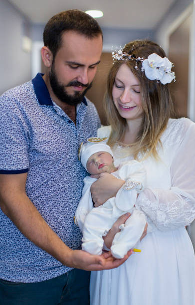 istock Baby in Mom and Dad's Arms 1390711919