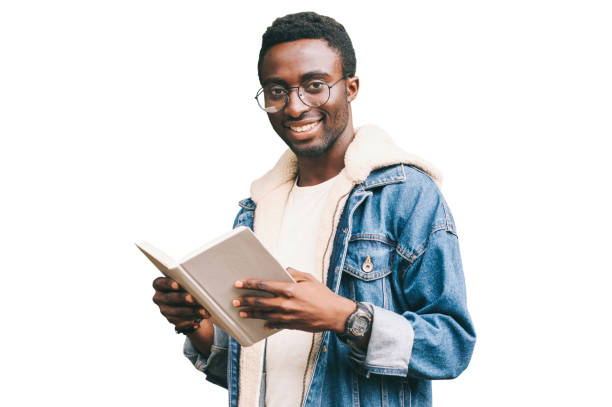 Portrait of young african man student with book looking at camera wearing eyeglasses isolated on white background stock photo
