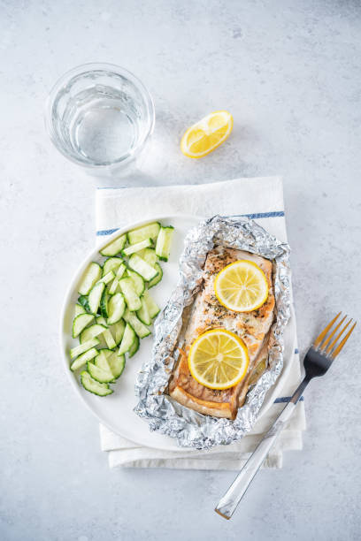 istock Salmon with herbs and lemon slices baked in a foil 1390714363