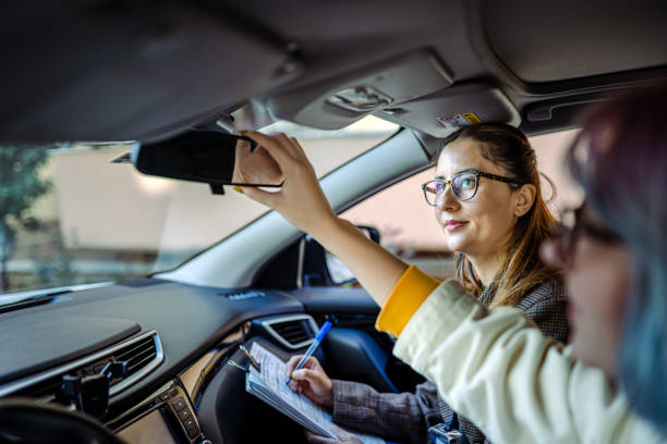 Teenager girl having driving lesson with female instructor Teenager girl having driving lesson with female instructor driving licence stock pictures, royalty-free photos & images