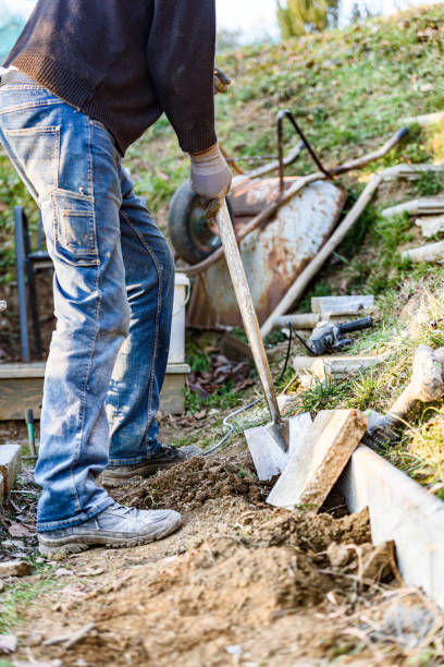 istock Working Mature Man in the Backyard Laying Patio Concrete Slabs 1390716506