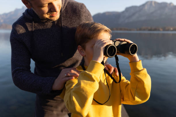 istock Father and son exploring mountain landscape with a binoculars 1390716628
